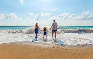 Family on a beach at sunset.