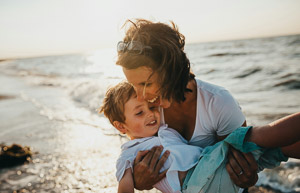 A mother with her son at the beach.